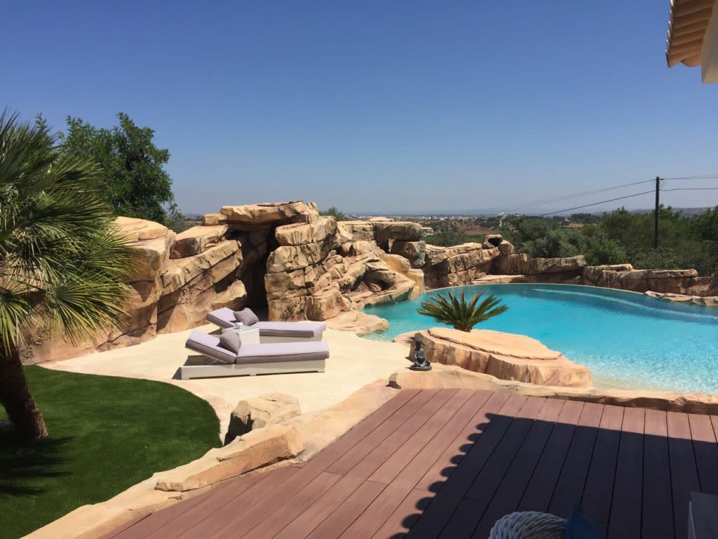 Private themed swimming pool with sculpted rockwork in Algarve, Portugal